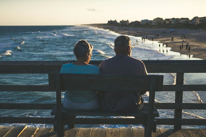 Couple on a bench overlooking the beach