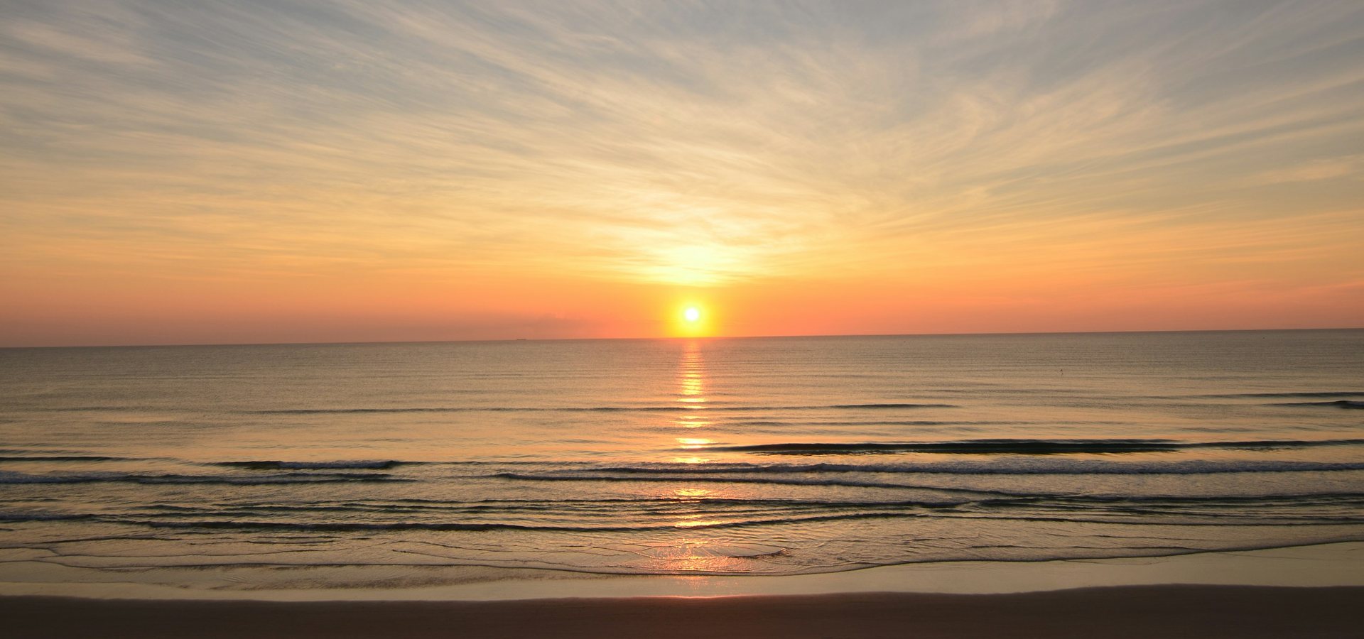 Sun rising over the ocean horizon